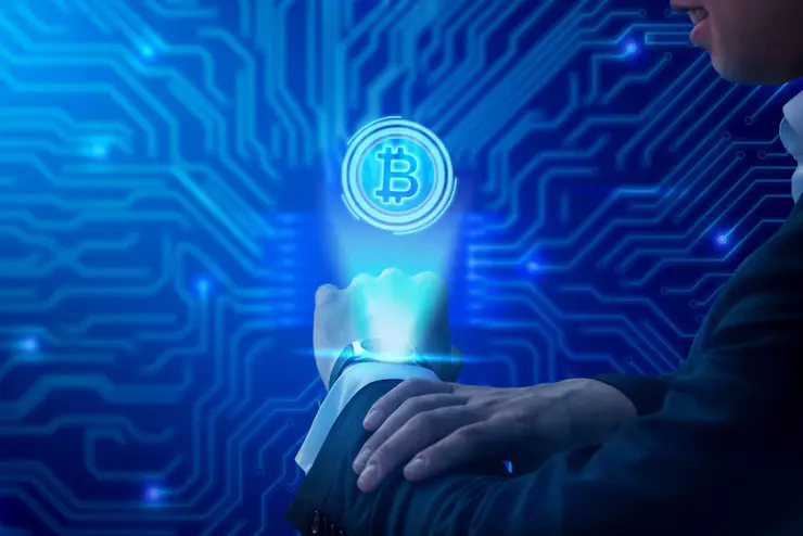 1. A man desplaying a crypto ama currency symbol, showcasing modern technology and finance.