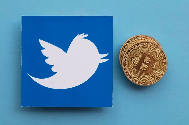 Blue Twitter Influencers logo and a Bitcoin coin on a light blue background, symbolizing the connection between social media and cryptocurrency. Bright, digital theme.