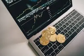 Crypto Trading Mistakes of a laptop with the Bitcoin symbol visible on the screen, representing online cryptocurrency transactions.